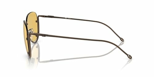 Side view of sunglasses with yellow lenses and thin metal frame.